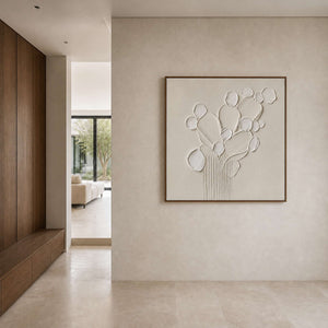 Square white botanical artwork displayed in a stone walnut entry hall.