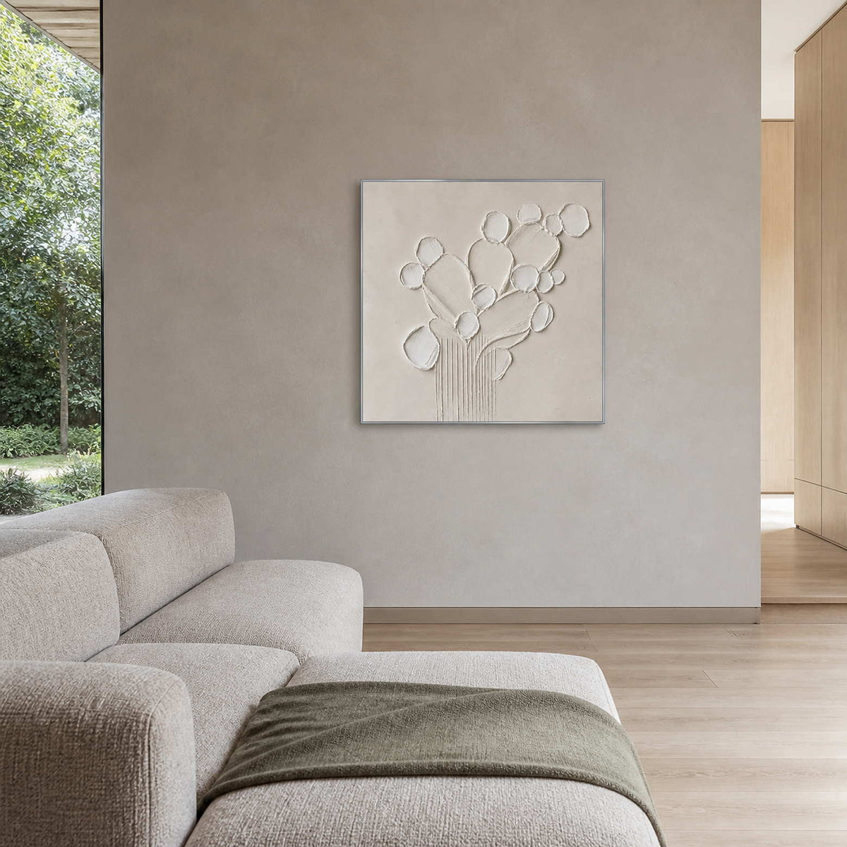 White relief artwork displayed in a taupe and light oak family lounge.