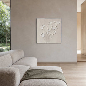 White relief artwork displayed in a taupe and light oak family lounge.
