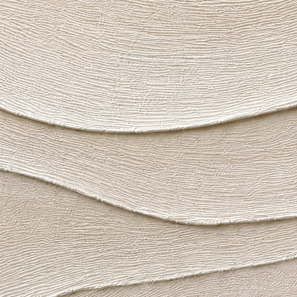 Close-up of fine combed lines across layered ivory relief.
