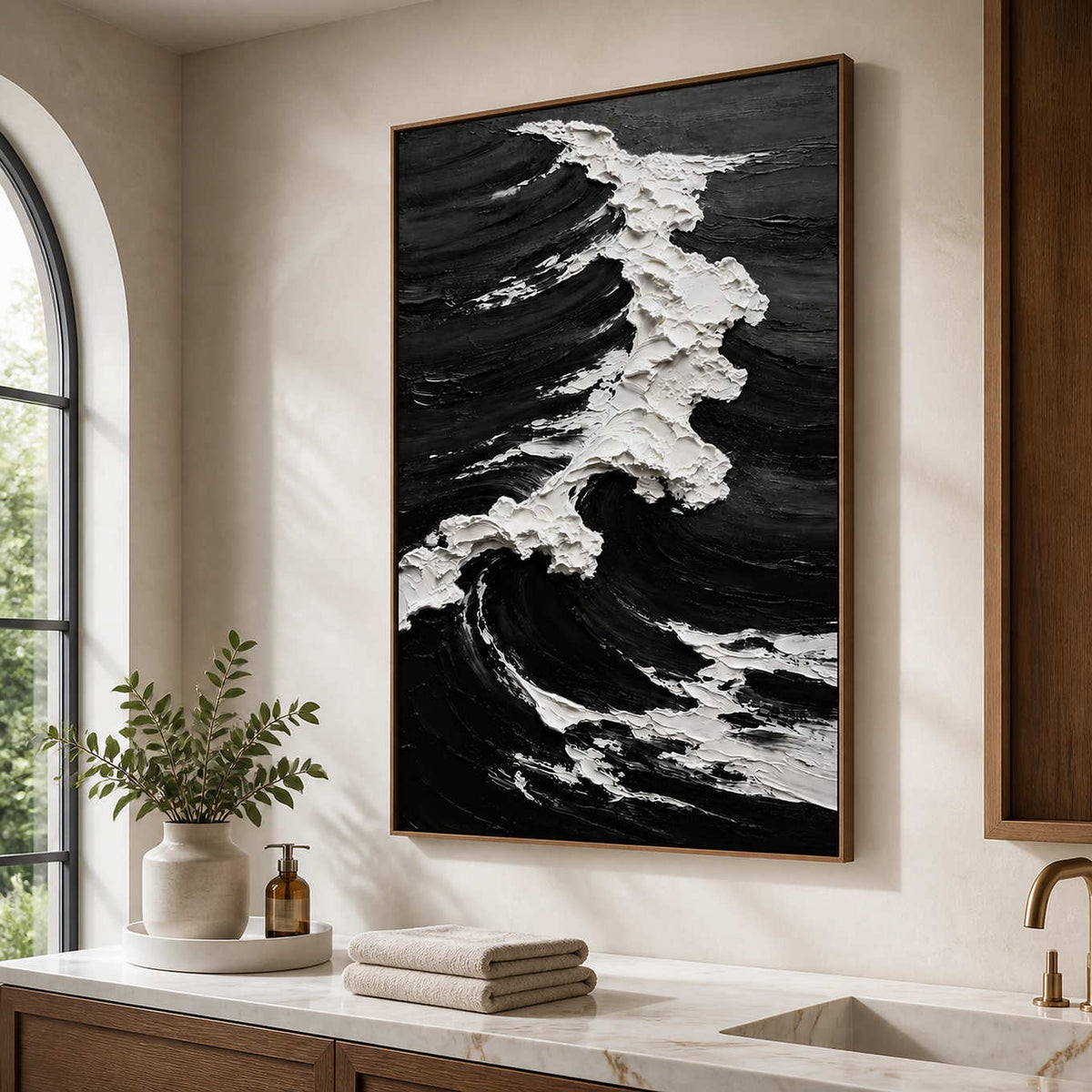 Wood framed monochrome wave painting with textured foam beside a bathroom vanity.