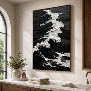 Wood framed monochrome wave painting with textured foam beside a bathroom vanity.
