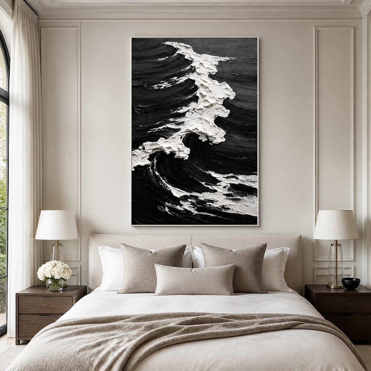 White framed coastal painting with a textured white crest above a pale bedroom headboard.