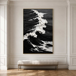 Gold framed coastal artwork with a white breaking wave above an upholstered hallway bench.
