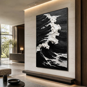 Black framed coastal artwork with rough white foam above a hotel lobby bench.