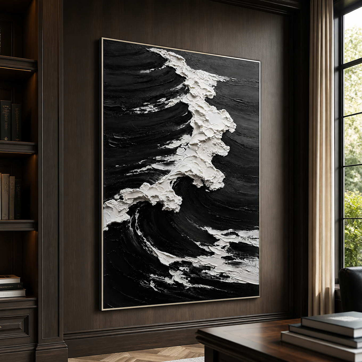Silver framed black and white wave artwork on a dark home office wall.