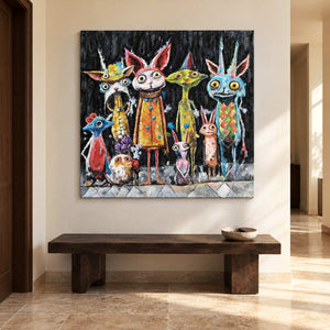 In an entryway above a console or bench, an artwork with no outer frame shows a row of wide-eyed animal-like characters in orange, turquoise, yellow and pink on black.