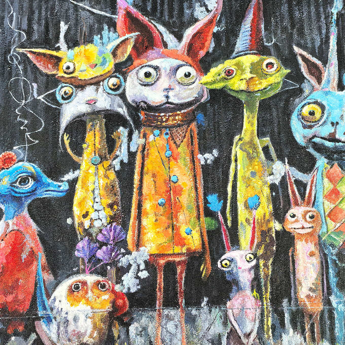 Close-up of wide eyes, pointed ears, orange clothing and colored dots on the central characters.