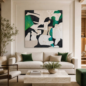Frameless green and cream abstract artwork above a sofa with dark green cushions.