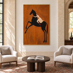 Wild at Heart in a gold frame above two cream armchairs and a round dark wood table in a commercial lobby.