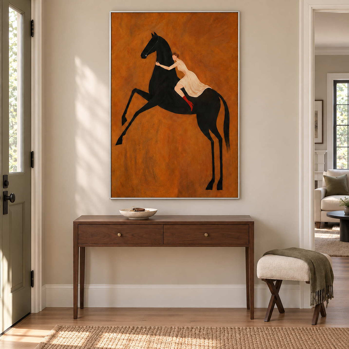 Wild at Heart in a silver frame above a narrow wood console and folding stool in a bright hallway.