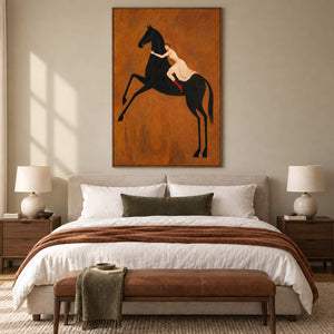 Wild at Heart in a wood frame above a cream bed with a rust throw and brown leather bench.