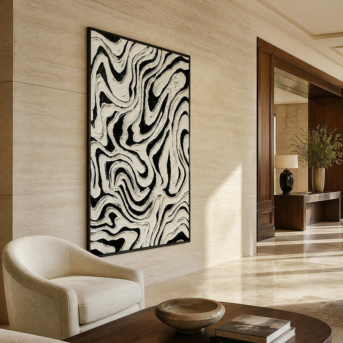 Black framed vertical abstract artwork with undulating white lines in a hotel lounge.