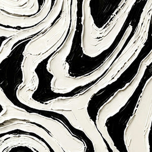 Close-up of thick white ridges curling around narrow black channels in abstract artwork.