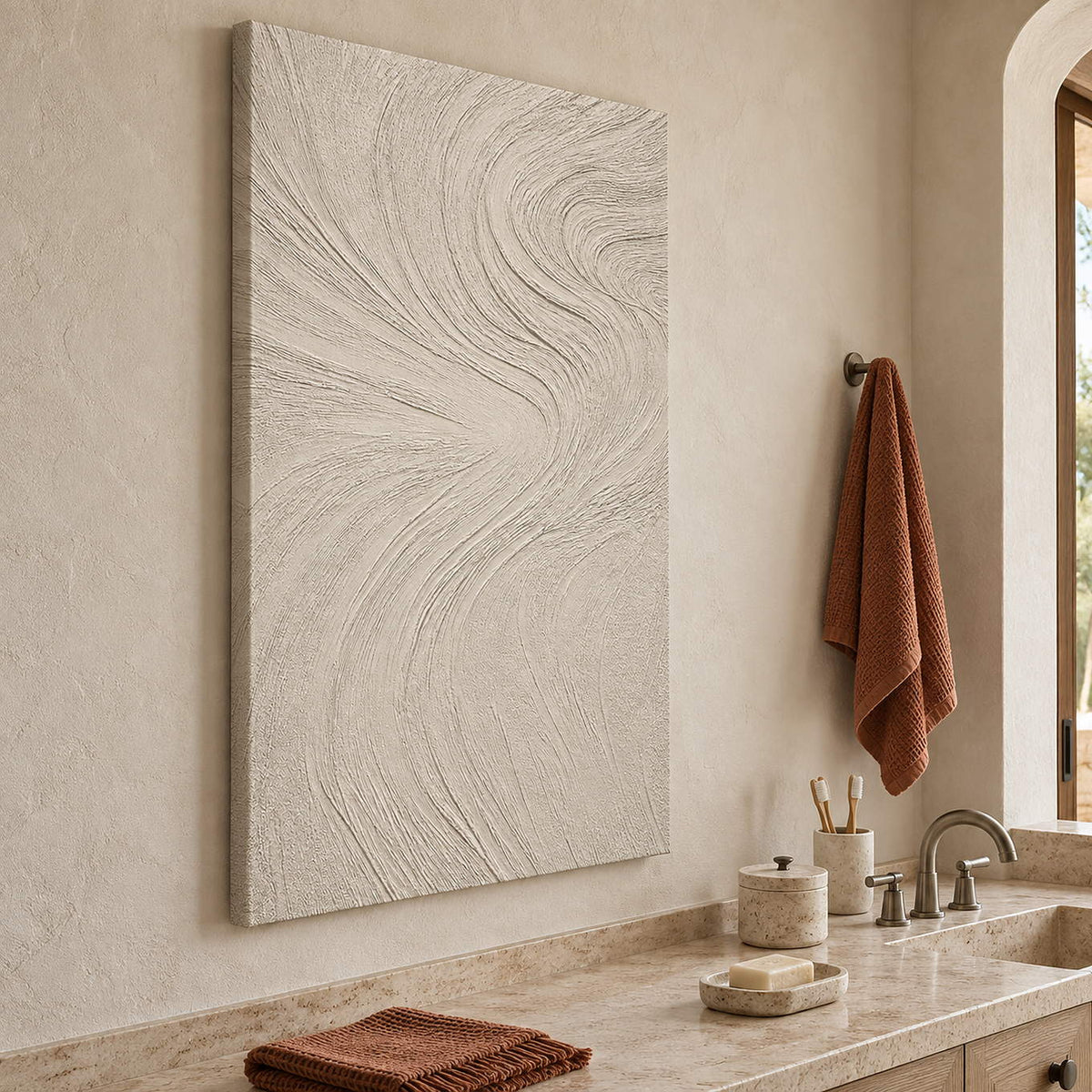 Ivory relief painting with fine flowing wave-like ridges without an outer frame beside a bathroom vanity.