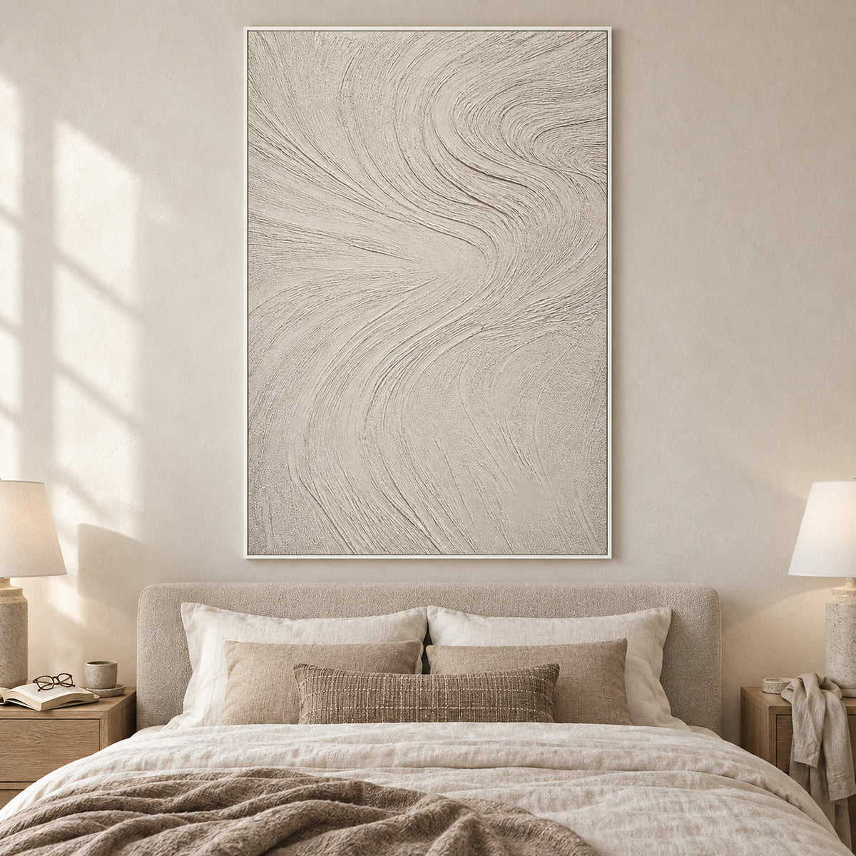 Ivory relief painting with fine flowing wave-like ridges in a white frame in a bedroom.