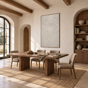 Ivory relief painting with fine flowing wave-like ridges in a brown wood frame in a dining room with bookshelves.