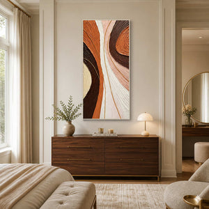 White-framed warm abstract wall art above a wooden dresser in a neutral bedroom.