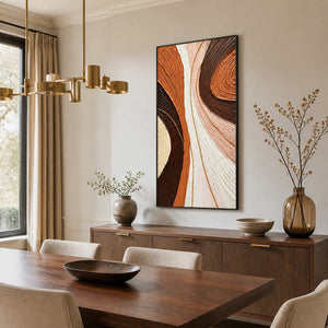 Black-framed textured abstract wall art above a sideboard beside a wooden dining table.
