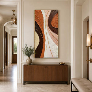 Gold-framed flowing abstract wall art above a wooden console in a paneled hallway.