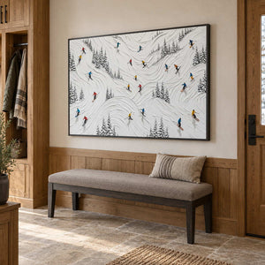 Winter at Play in a black frame above a padded entryway bench surrounded by warm wood paneling.