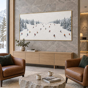 Winter Joy in a gold frame above a light wood sideboard between brown leather chairs in a mountain-view lobby.