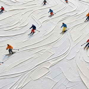 Close-up of Winter Joy showing small skiers in colorful clothing turning between curved ridges and tracks in thick white snow texture.