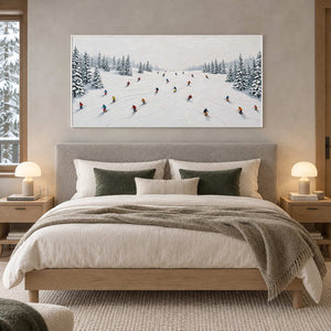 Winter Joy in a white frame above a gray upholstered bed with white bedding and deep green cushions.