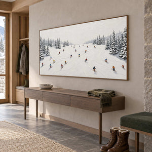 Winter Joy in a wood frame above a slim hallway console with a green throw and winter boots nearby.