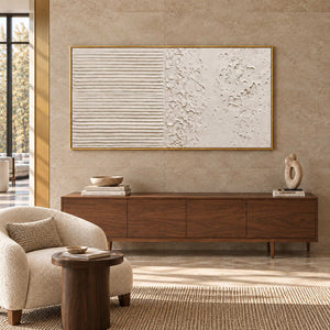 Wordless Dialogue in a gold frame above a dark wood sideboard beside a cream lounge chair in a commercial lobby.