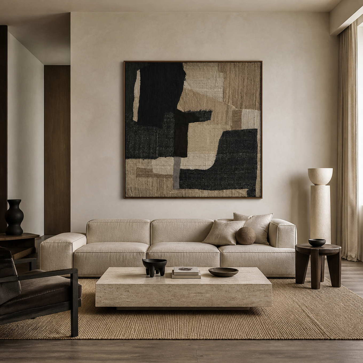 Woven Through Time in a wood frame above a cream sofa, pairing black shapes and tan layers with a warm neutral living room.