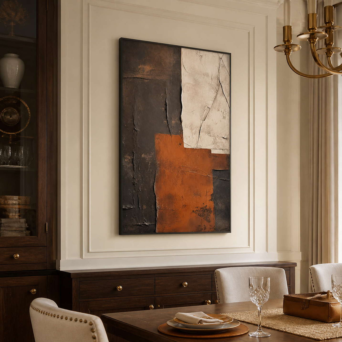 Black framed rust and cream abstract artwork beside a formal dining table.